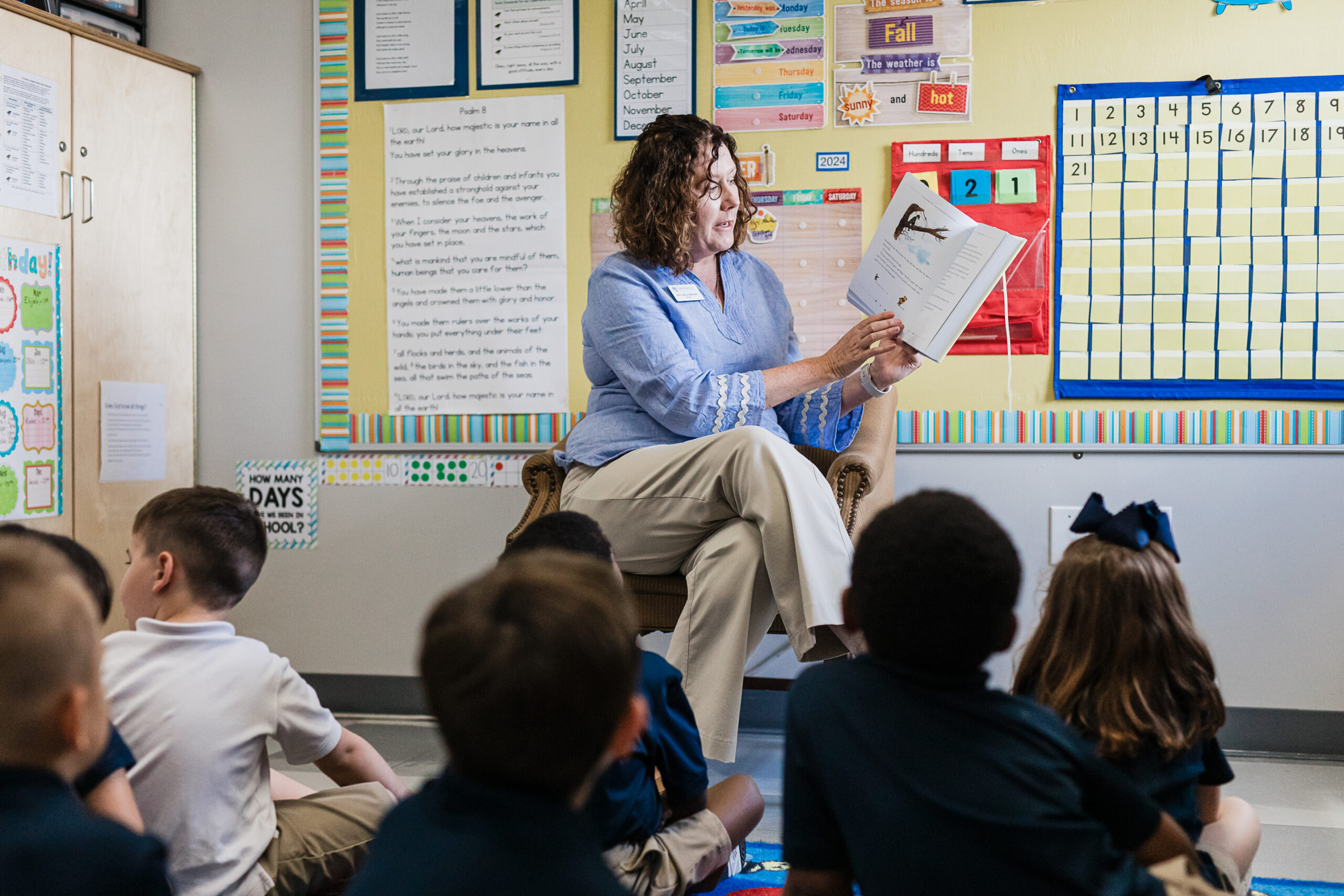 A Kindergarten teacher reads to students at Providence Classical School in Klein, TX.
