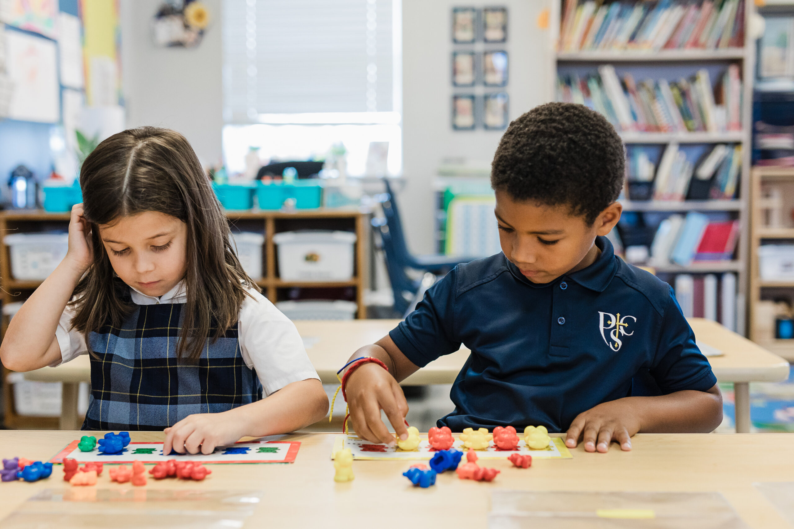 Kindergarten boy and girl using math manipulatives to learn math concepts at Providence Classical School in Spring, TX.