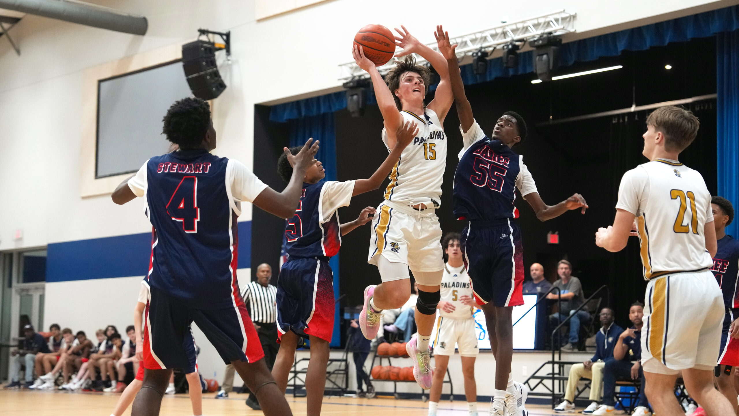 Providence Classical School Varsity Boys Basketball player shooting a basket