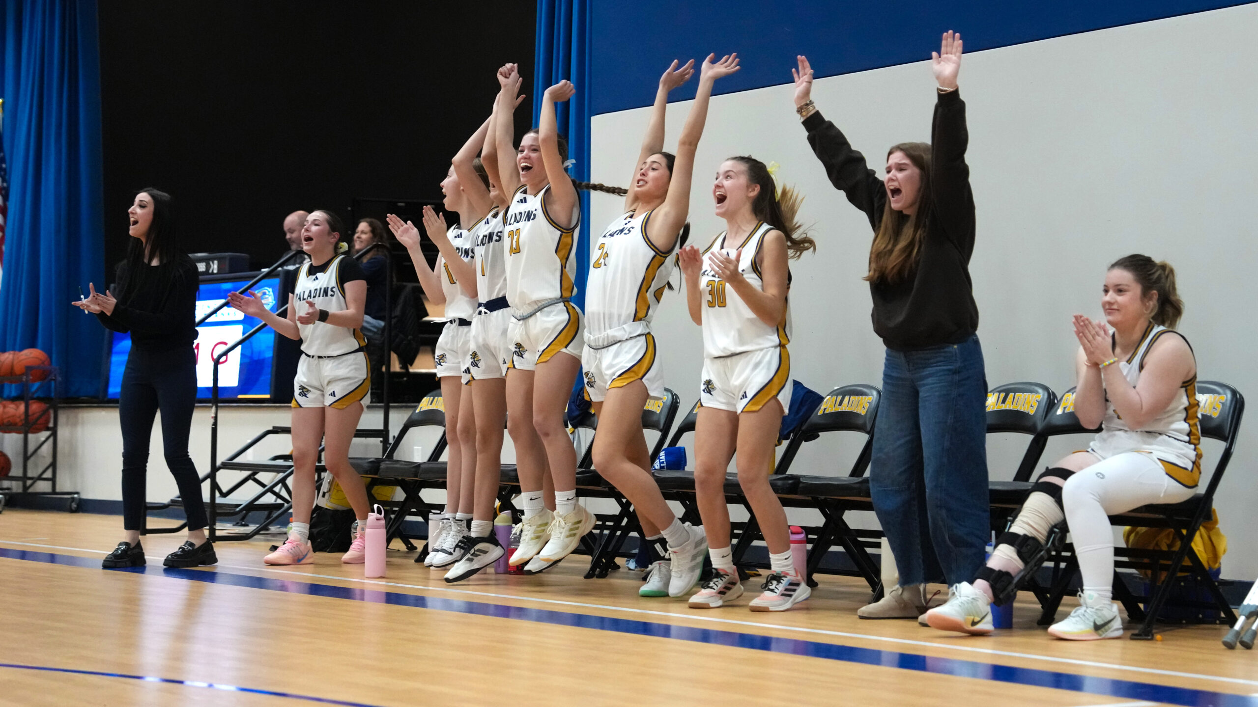 Providence Classical School Varsity Girls Basketball team cheering courtside
