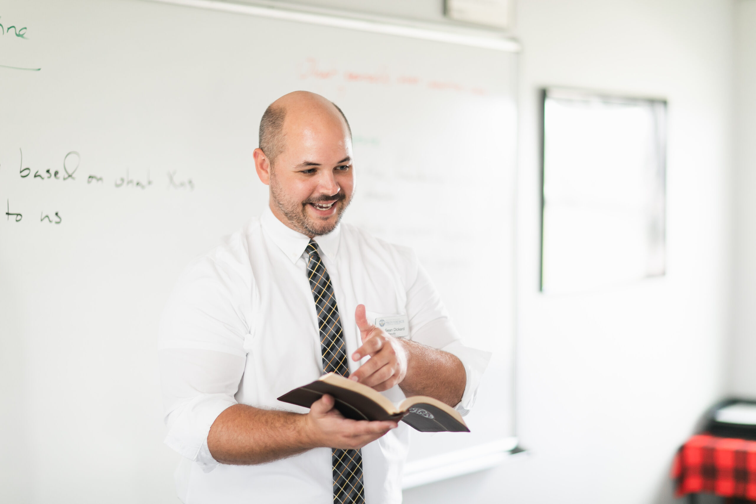 Providence Classical School teacher holding Bible