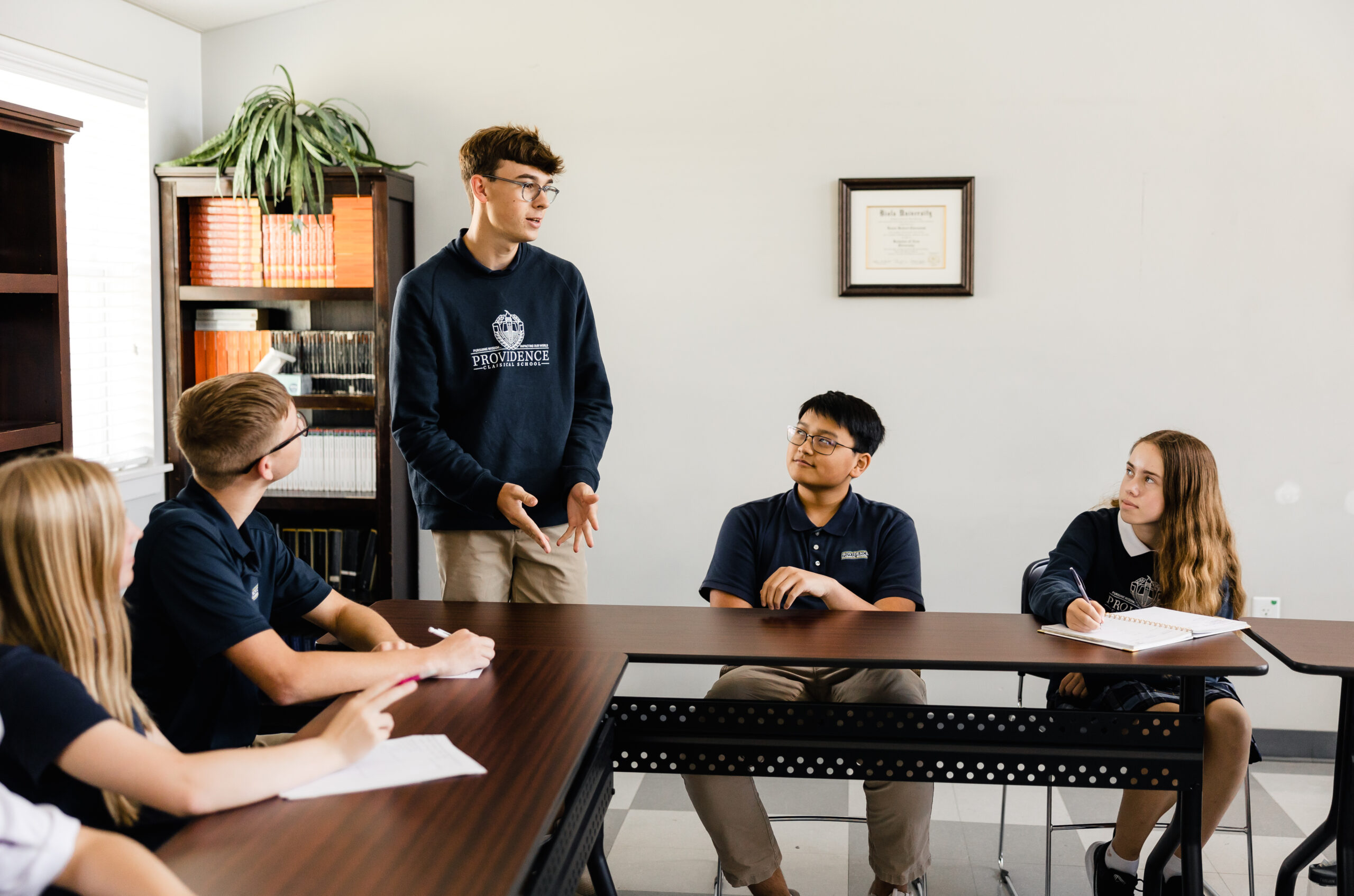 High school students having an engaging discussion at Providence Classical School in Spring, TX