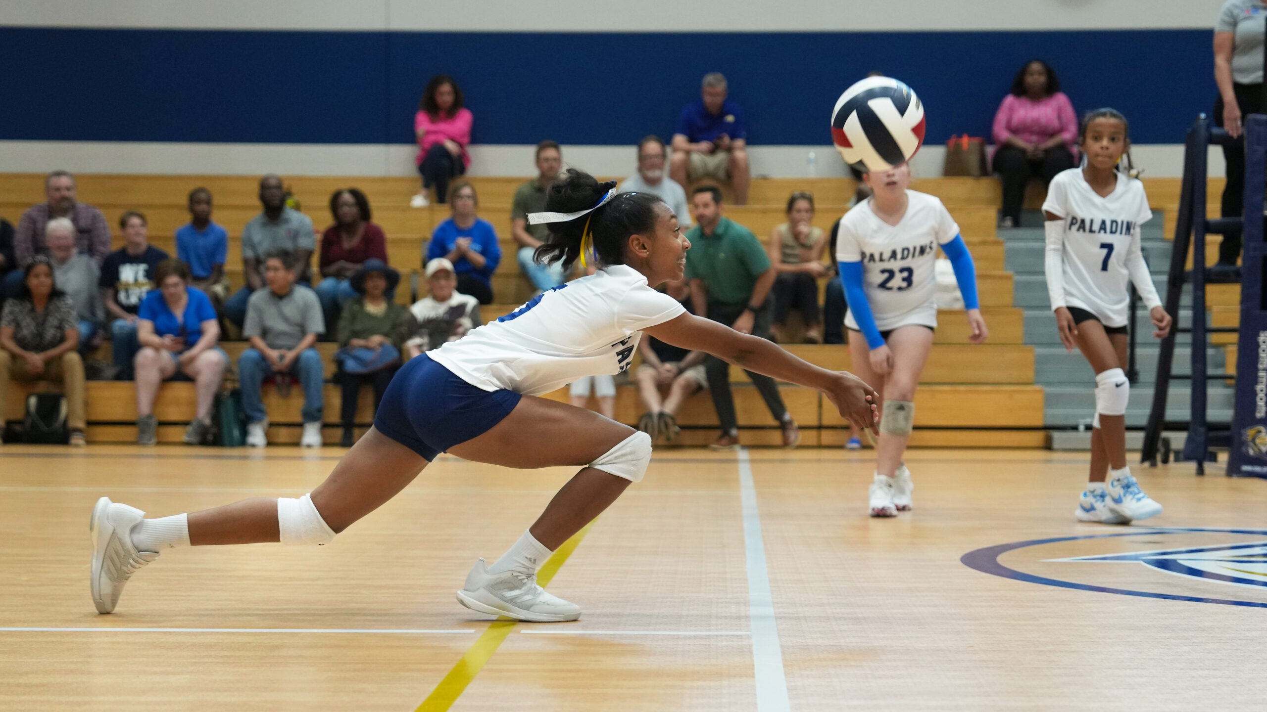 Providence Classical School Middle School Girls Volleyball player diving for shot