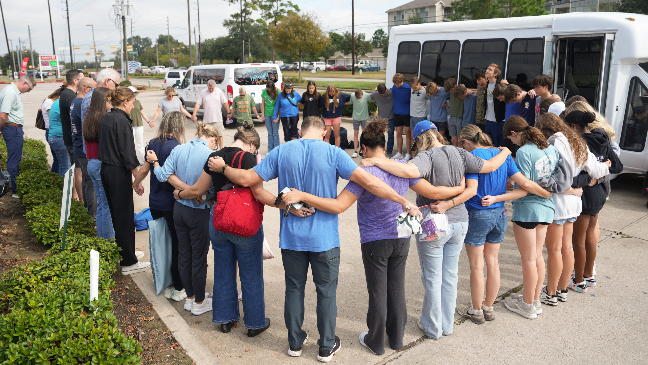 Providence Classical School athletes praying at an Athletics student send-off before traveling to Cross Country State Championship