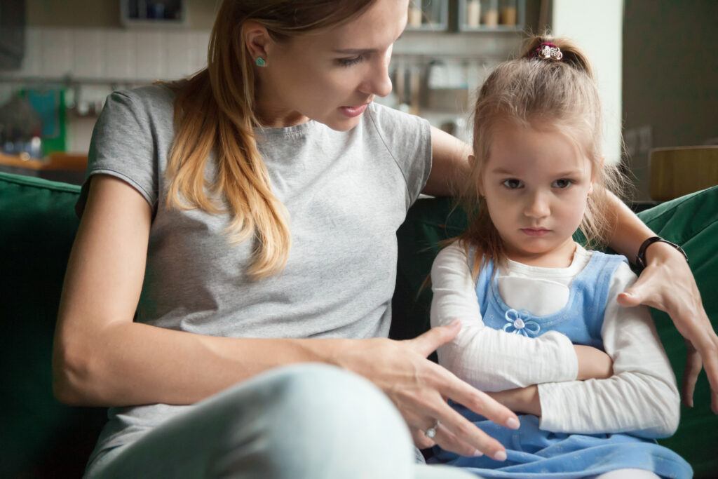 Angry offended little girl ignoring mother words