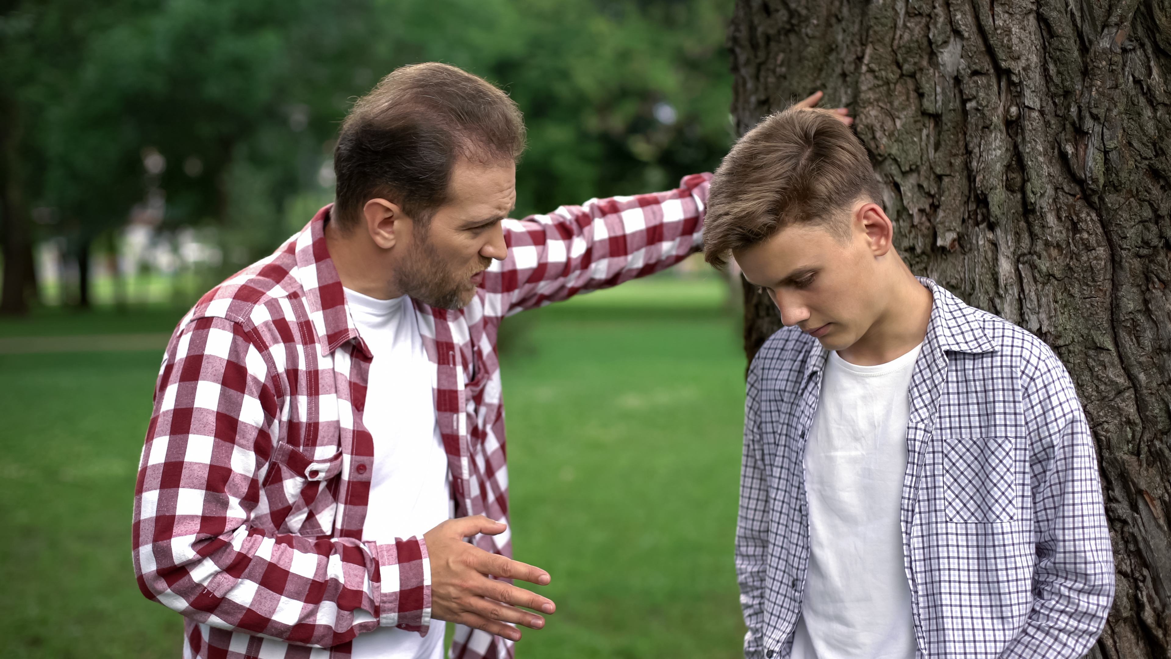 Strict dad scolding son for bad marks at school