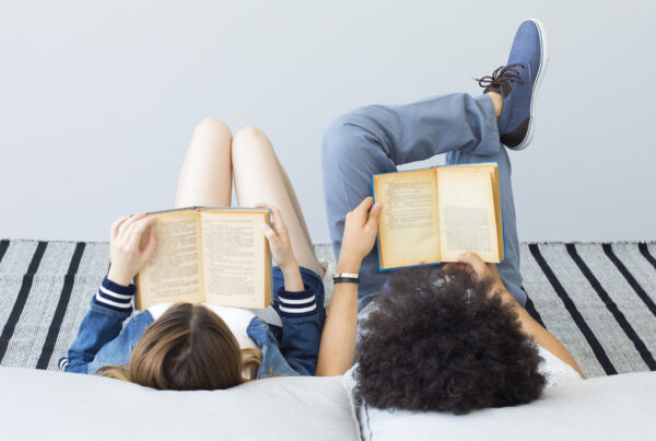 Pre-teen and Teenage girl and boy reading books