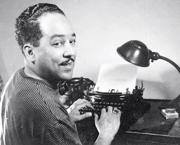 Langston Hughes at typewriter